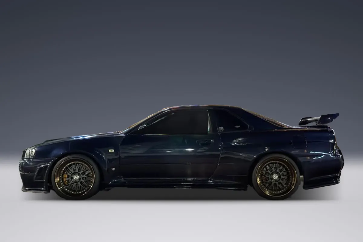 Dark blue Nissan Skyline GT-T R34, side view
